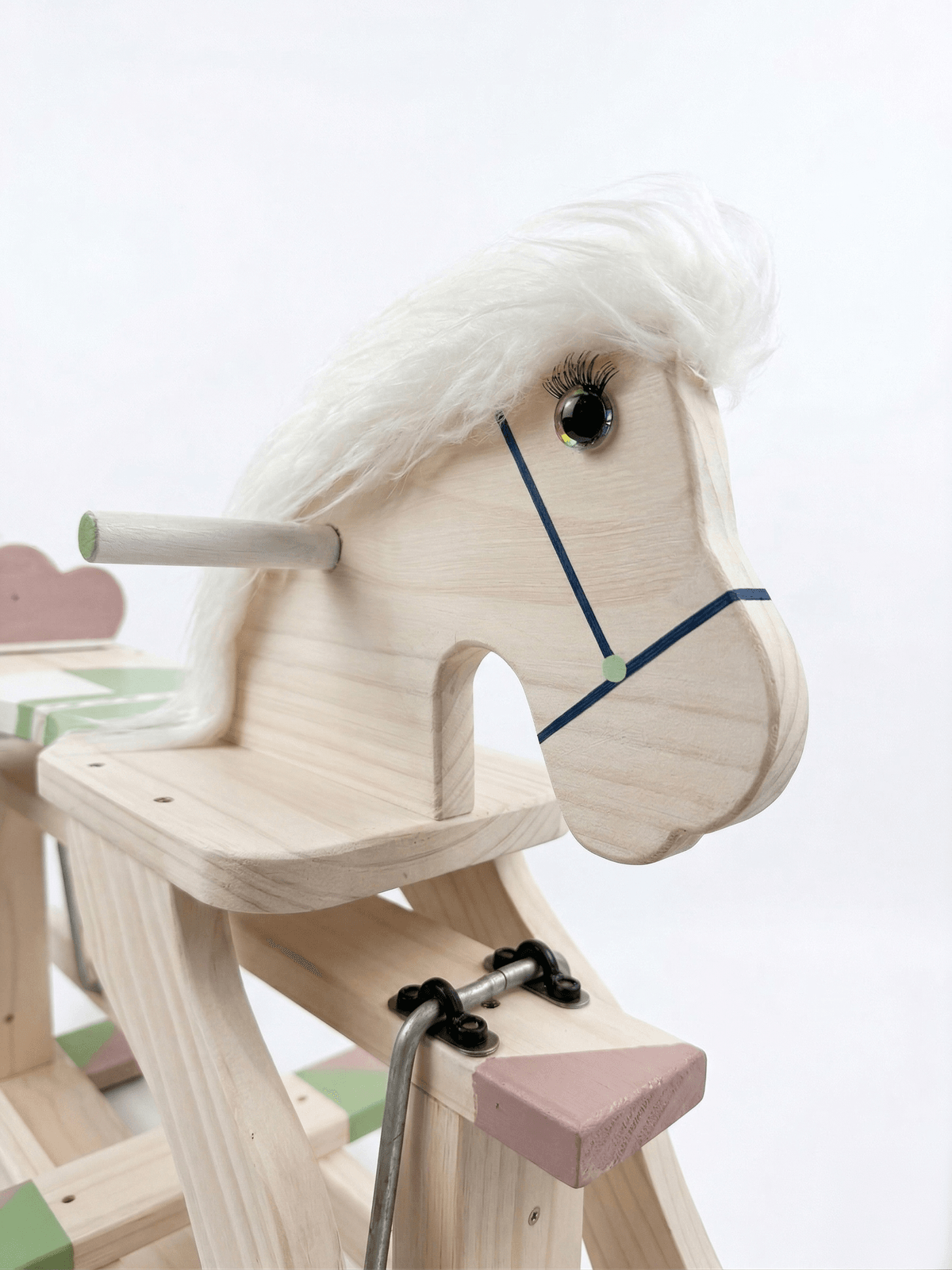 Close-up detail of the rocking horse head showing hand-finished craftsmanship